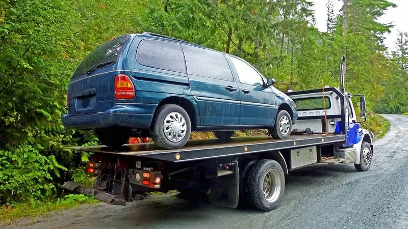 Montreal flatbed towing a cargo van