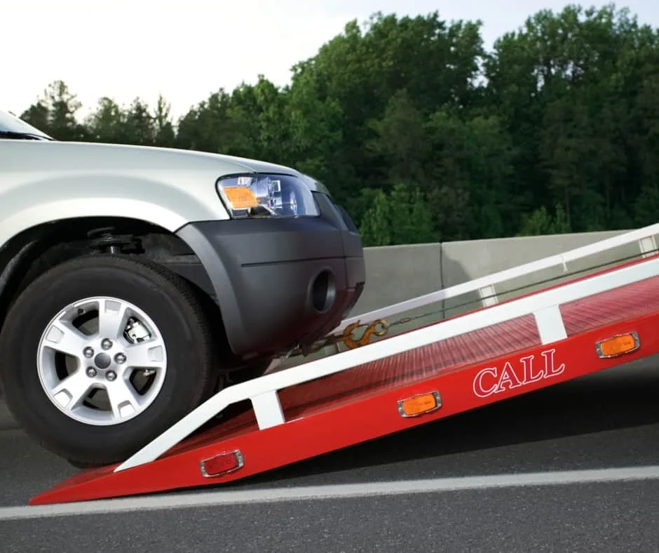 Montreal tow truck loading a vehicle on a residential street